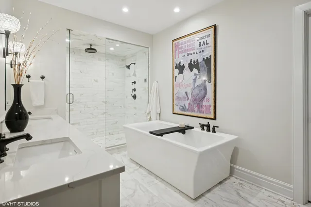 a bathroom with a tub sink and mirror
