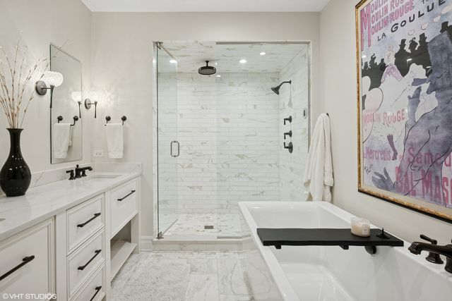 a bathroom with a double vanity sink toilet mirror and shower