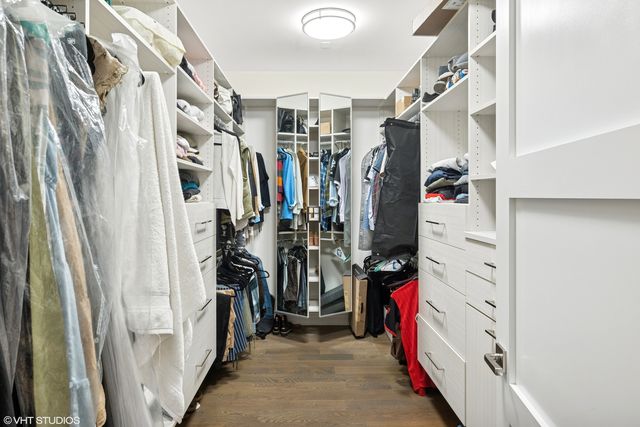 a view of walk in closet with clothes