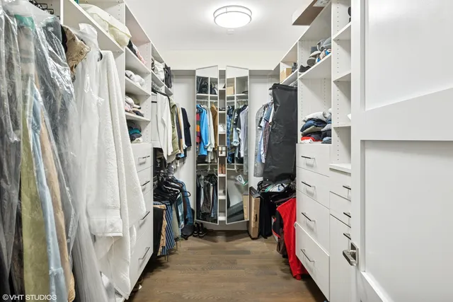 a view of walk in closet with clothes