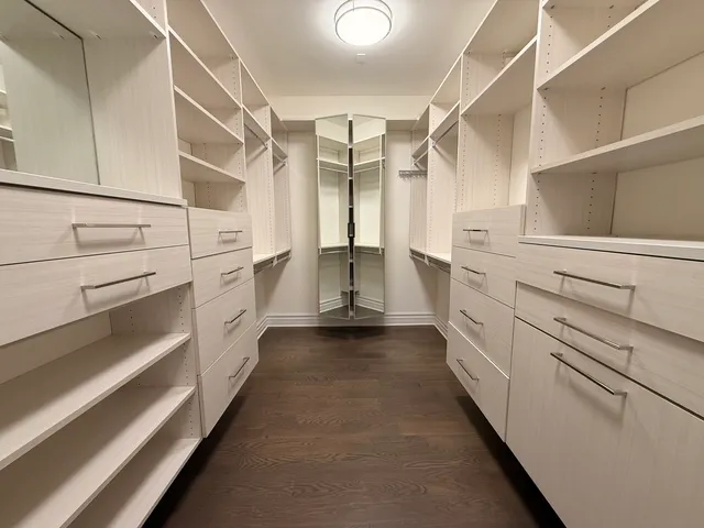 a kitchen with white cabinets and sink