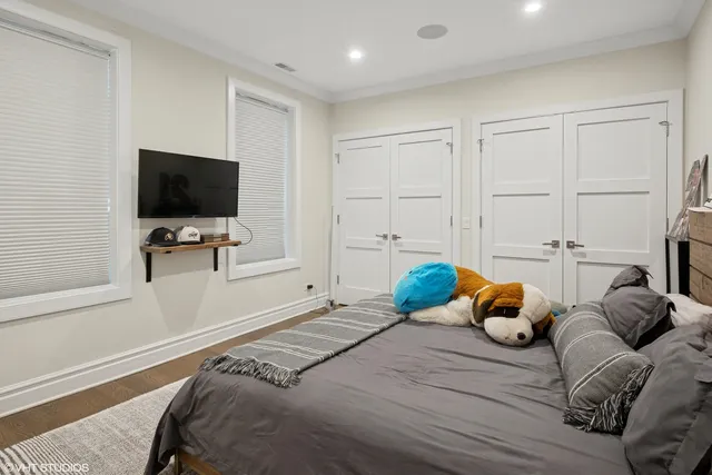a bedroom with furniture and a flat screen tv