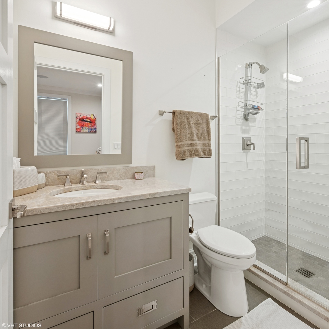 1851 North Halsted Street, Unit 2 Chicago, IL 60614 - Photo 25 of 31 a bathroom with a toilet sink vanity and shower