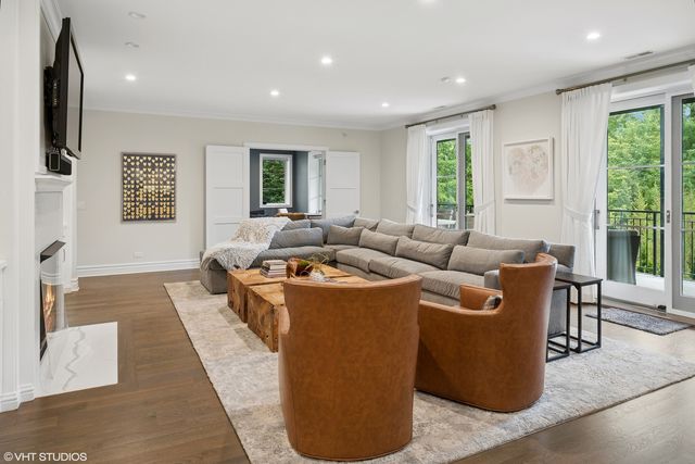 a living room with furniture and large windows