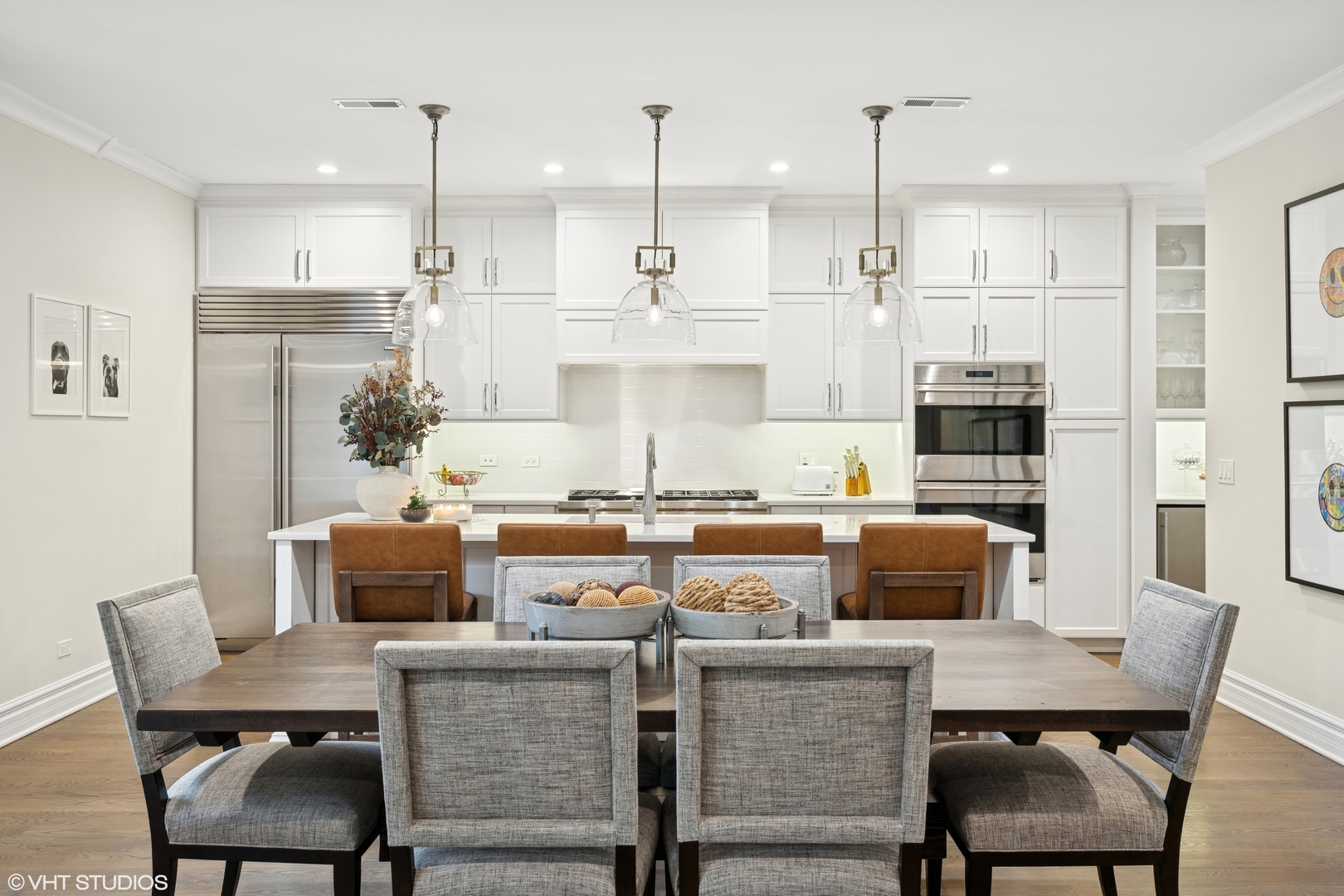 1851 North Halsted Street, Unit 2 Chicago, IL 60614 - Photo 5 of 31 a kitchen with stainless steel appliances granite countertop a stove a refrigerator a kitchen island a dining table and chairs