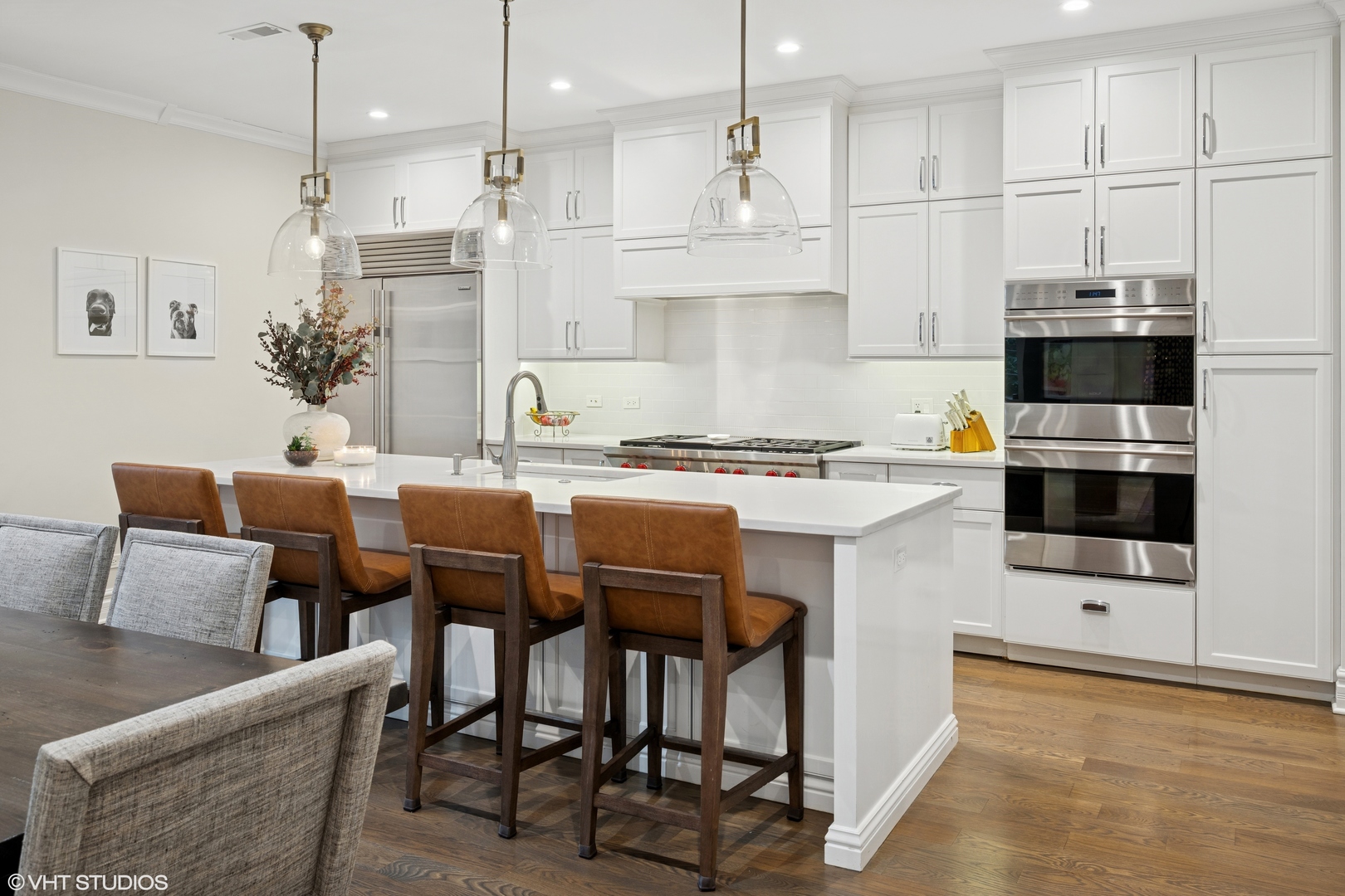 1851 North Halsted Street, Unit 2 Chicago, IL 60614 - Photo 6 of 31 a kitchen with stainless steel appliances kitchen island granite countertop a table chairs microwave and sink