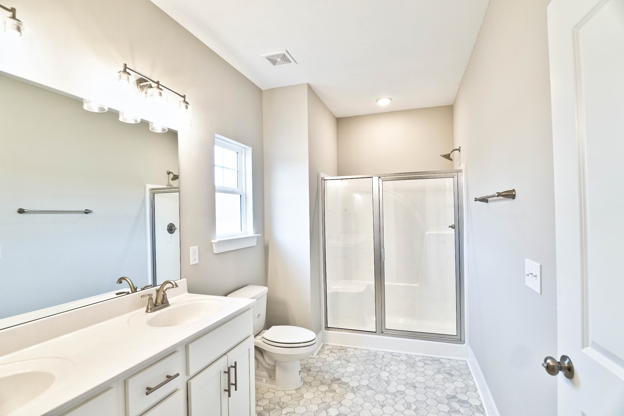 711 Vrabel Road Murfreesboro, TN 37130 - Photo 10 of 22 Primary bath includes double vanities and bench seating in the shower.