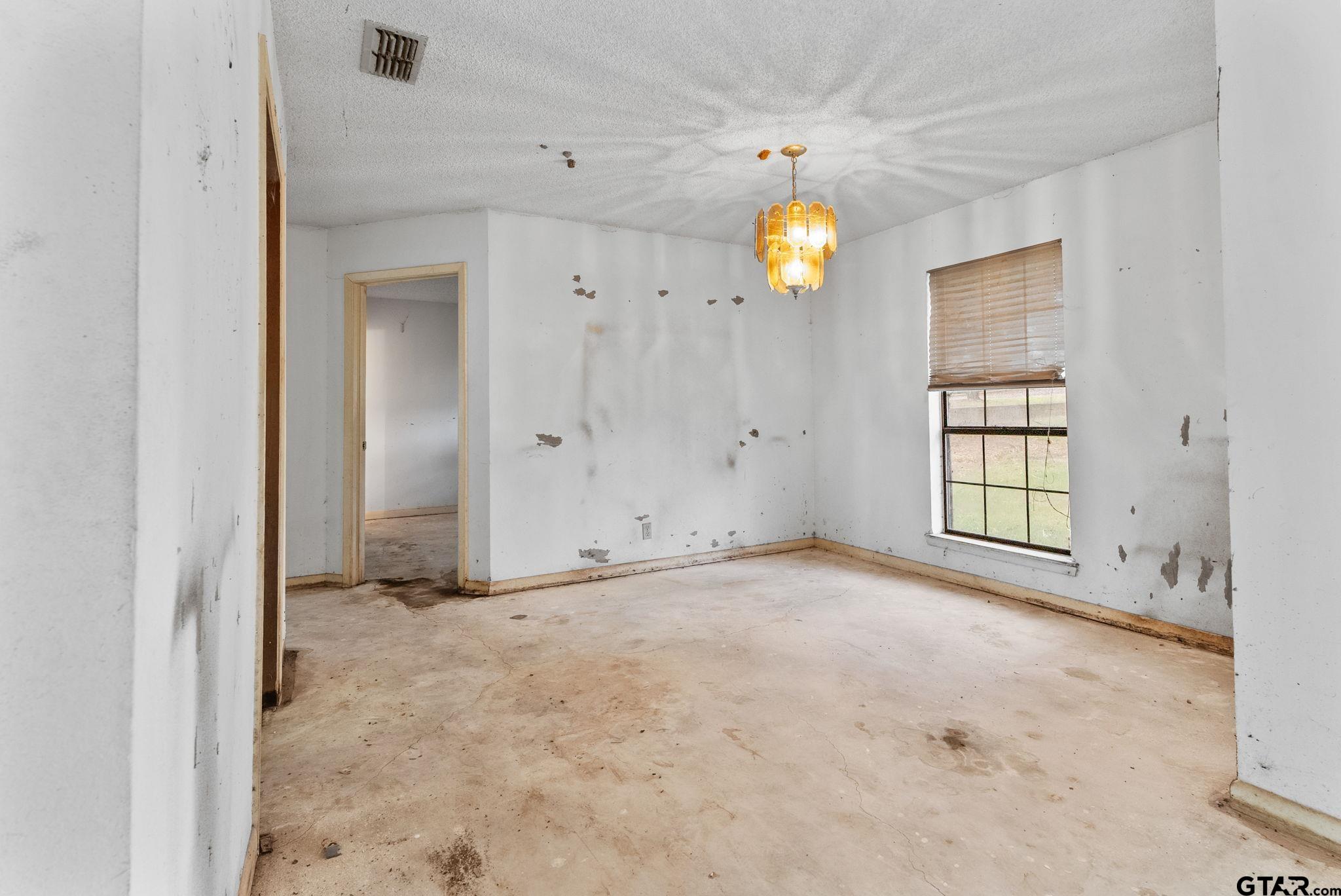 21135 County Road 1291 Flint, TX 75762 - Photo 17 of 25 a view of an empty room with window and chandelier fan