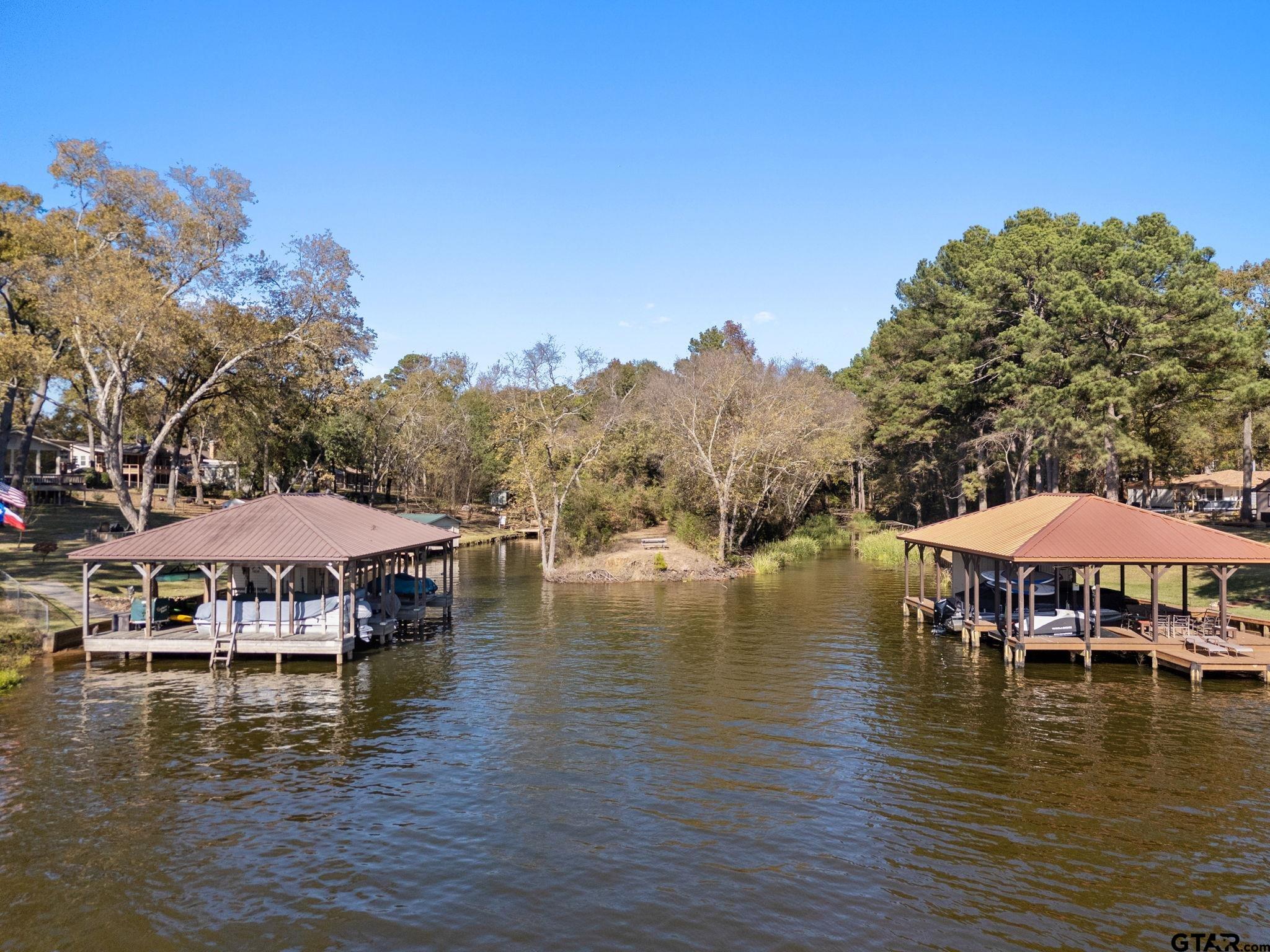 21135 County Road 1291 Flint, TX 75762 - Photo 6 of 25 a view of a lake with a table and chairs