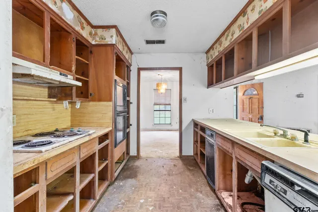 a kitchen with stainless steel appliances granite countertop a stove and a sink