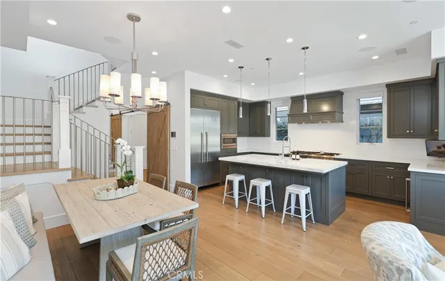 a large kitchen with a table and chairs