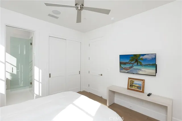 a bedroom with a bed and a painting on the wall