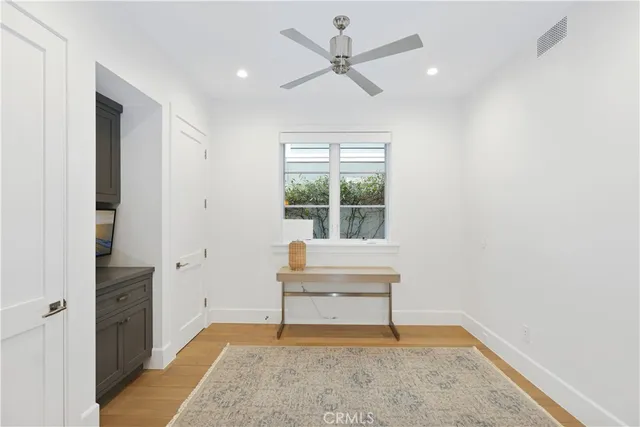 a view of an empty room with a window and a workspace