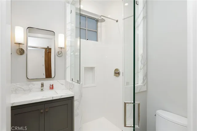 a kitchen that has a sink a center island stainless steel appliances and cabinets