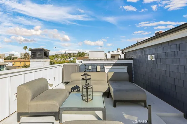 a view of a terrace with furniture and a city view