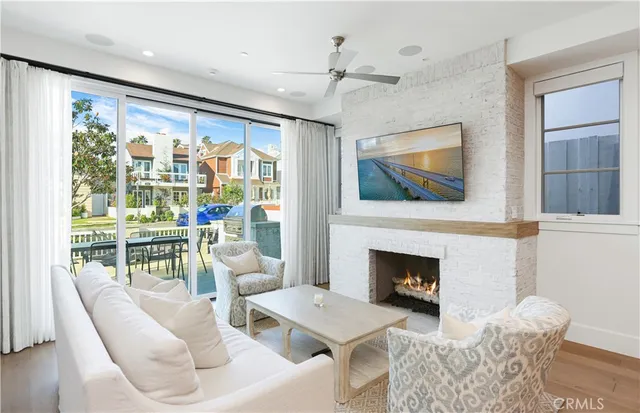 a living room with furniture a fireplace and a flat screen tv