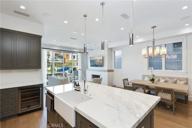 a large kitchen with kitchen island a sink table and chairs