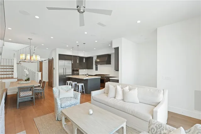 a living room with furniture and kitchen view