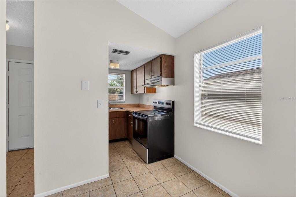 4915 Billy Direct Lane Lutz, FL 33559 - Photo 14 of 73 a kitchen with a refrigerator and a stove top oven