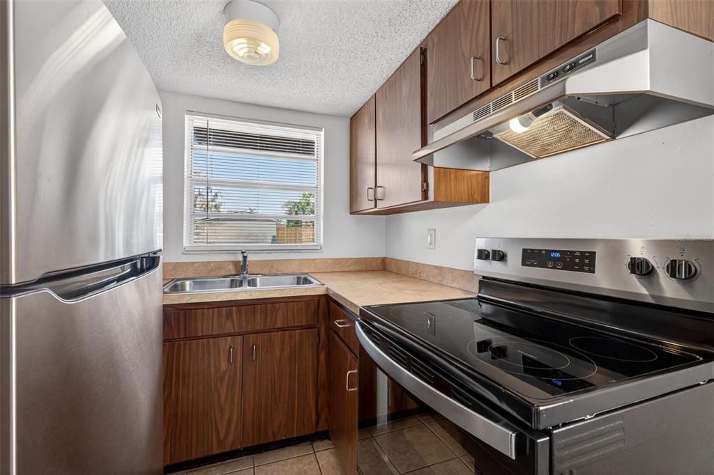 4915 Billy Direct Lane Lutz, FL 33559 - Photo 17 of 73 a kitchen with a stove a sink and a refrigerator