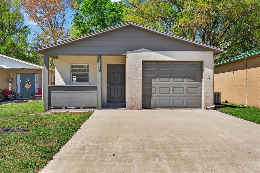 4915 Billy Direct Lane Lutz, FL 33559 - Photo 2 of 73 a front view of a house with a yard and garage