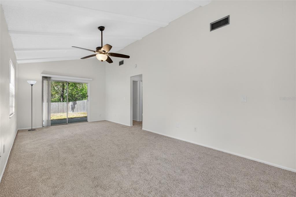 4915 Billy Direct Lane Lutz, FL 33559 - Photo 30 of 73 an empty room with windows and fan