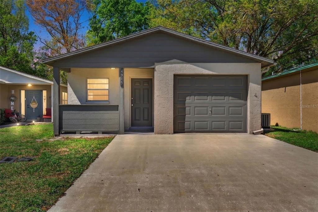 4915 Billy Direct Lane Lutz, FL 33559 - Photo 3 of 73 a front view of a house with a yard and garage