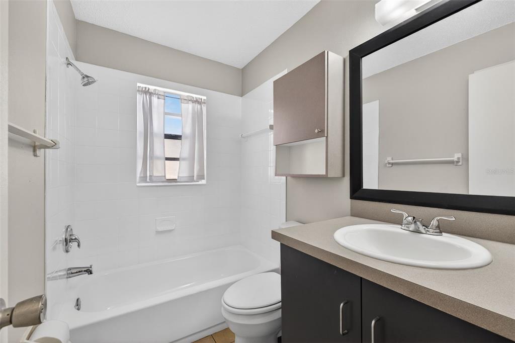 4915 Billy Direct Lane Lutz, FL 33559 - Photo 37 of 73 a bathroom with a sink toilet tub and shower