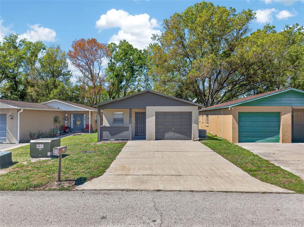 4915 Billy Direct Lane Lutz, FL 33559 - Photo 4 of 73 a front view of a house with a yard and trees