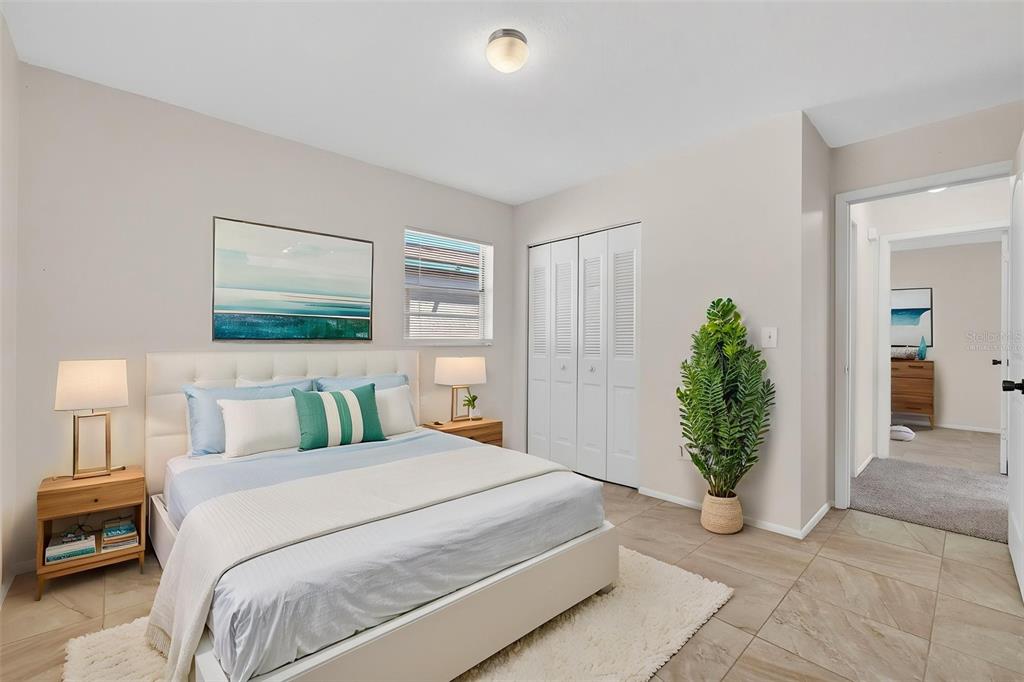 4915 Billy Direct Lane Lutz, FL 33559 - Photo 43 of 73 a bedroom with a bed and a potted plant