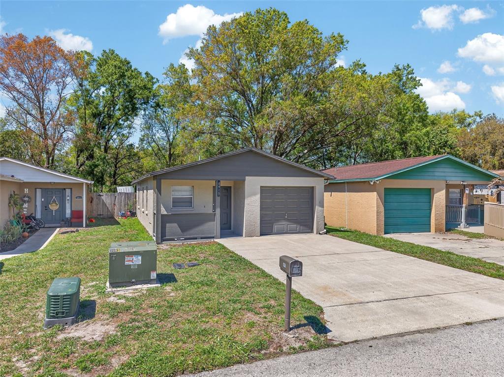 4915 Billy Direct Lane Lutz, FL 33559 - Photo 6 of 73 a front view of a house with a yard and garage