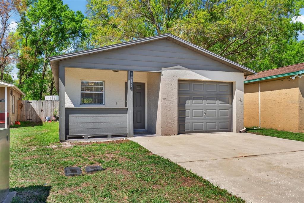 4915 Billy Direct Lane Lutz, FL 33559 - Photo 8 of 73 a front view of a house with a yard and garage