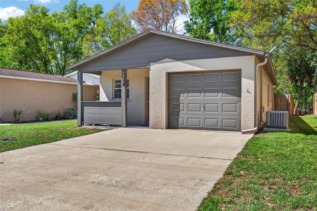 4915 Billy Direct Lane Lutz, FL 33559 - Photo 10 of 73 a front view of a house with a yard and garage
