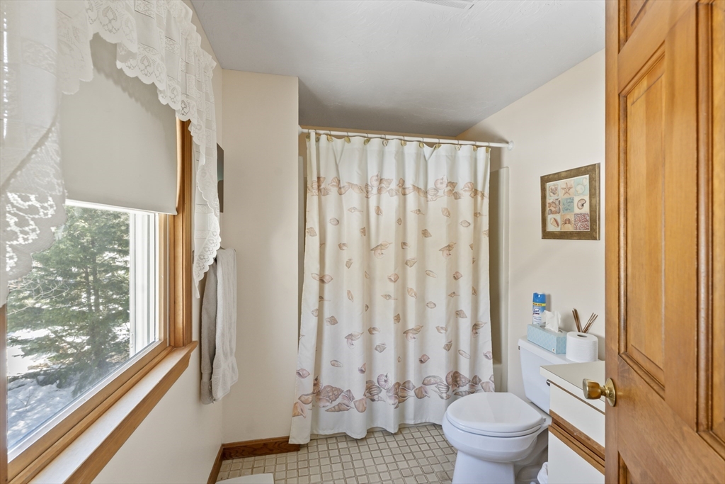 52 Windsor Drive Edgartown, MA 02539 - Photo 11 of 11 a bathroom with a toilet and a shower curtain