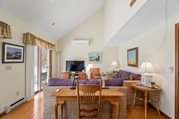 a living room with furniture a wooden floor and a flat screen tv