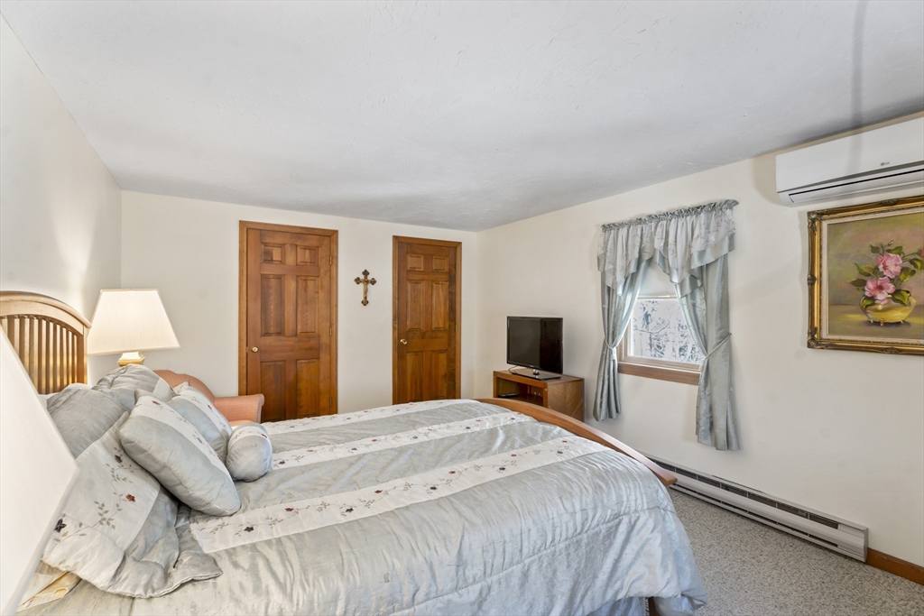 52 Windsor Drive Edgartown, MA 02539 - Photo 10 of 11 a bedroom with a bed and wooden floor
