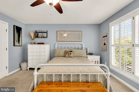 a bedroom with a bed and wall painting