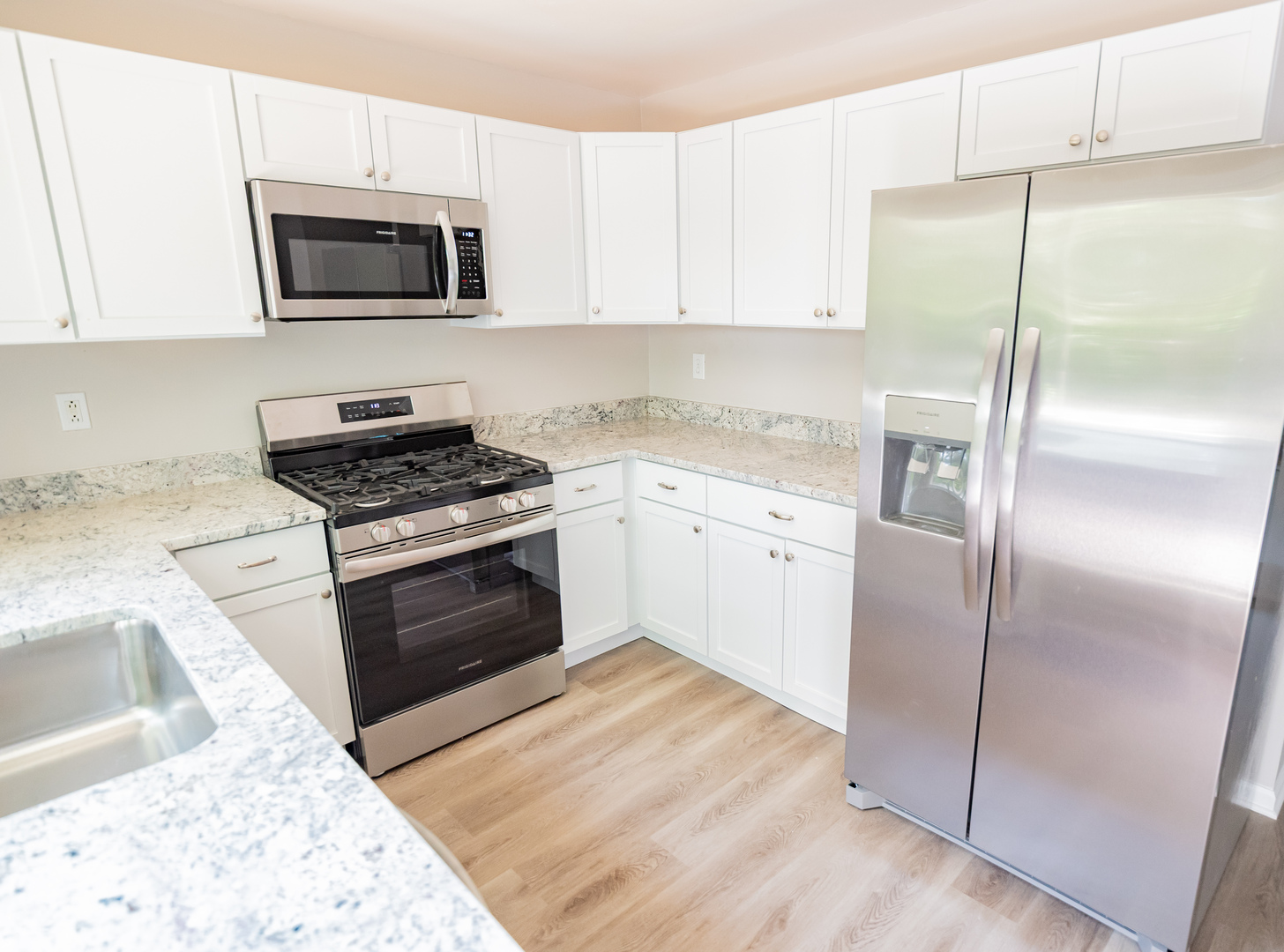 447 Yorkshire Square Bolingbrook, IL 60440 - Photo 8 of 23 a kitchen with a refrigerator stove and white cabinets