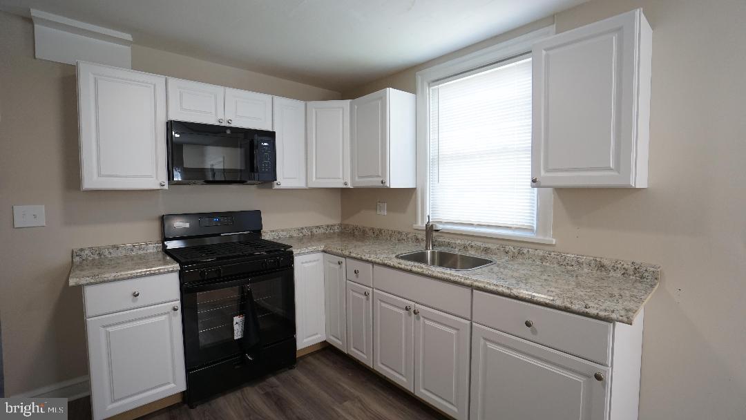 104 Bethlehem Pike, Unit B Colmar, PA 19446 - Photo 2 of 12 a kitchen with granite countertop white cabinets sink and stainless steel appliances