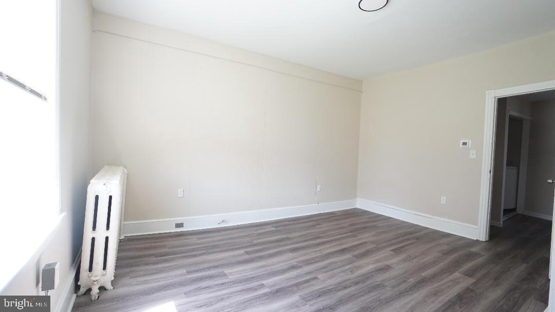 104 Bethlehem Pike, Unit B Colmar, PA 19446 - Photo 4 of 12 an empty room with wooden floor and a window