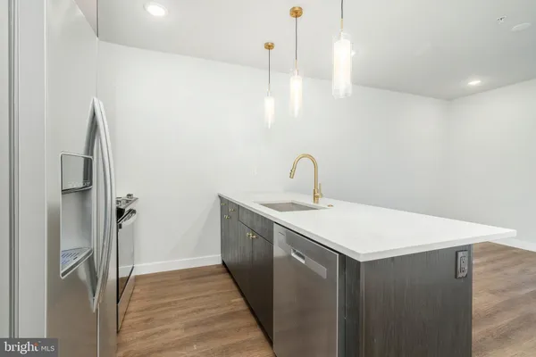 a kitchen with a sink and refrigerator