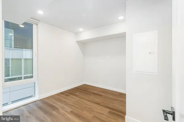 a view of empty room with wooden floor
