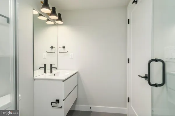 a bathroom with a sink a mirror and shower