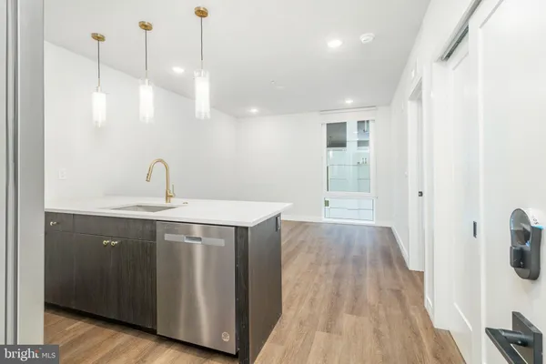 a view of a kitchen with wooden floor