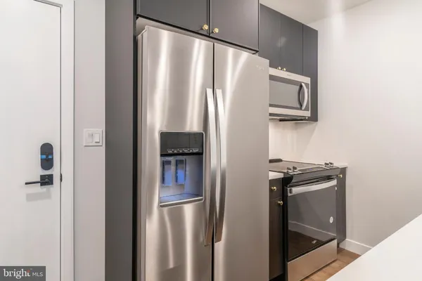 a metallic refrigerator freezer sitting in a kitchen