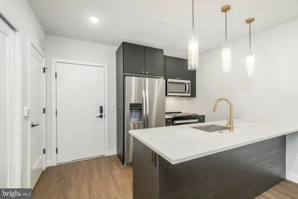 a kitchen with a sink a refrigerator and a stove