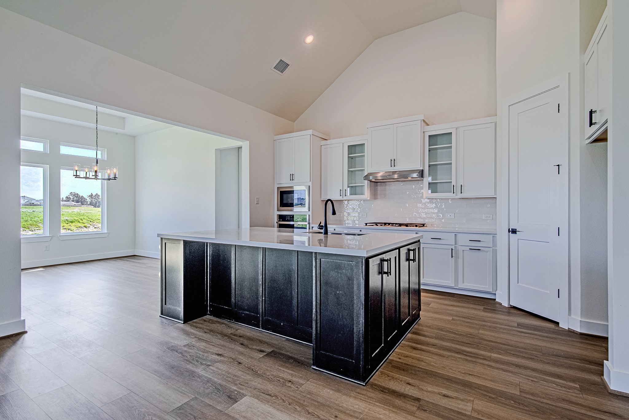 157 Peninsula Point Drive Montgomery, TX 77356 - Photo 5 of 33 a kitchen with stainless steel appliances granite countertop a sink cabinets and wooden floor