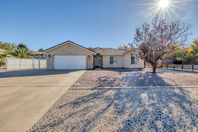 830 Larkspur Road St. George, UT 84790 - Photo 1 of 1 Ranch-style home featuring concrete driveway, a gate, a tile roof, and an attached garage