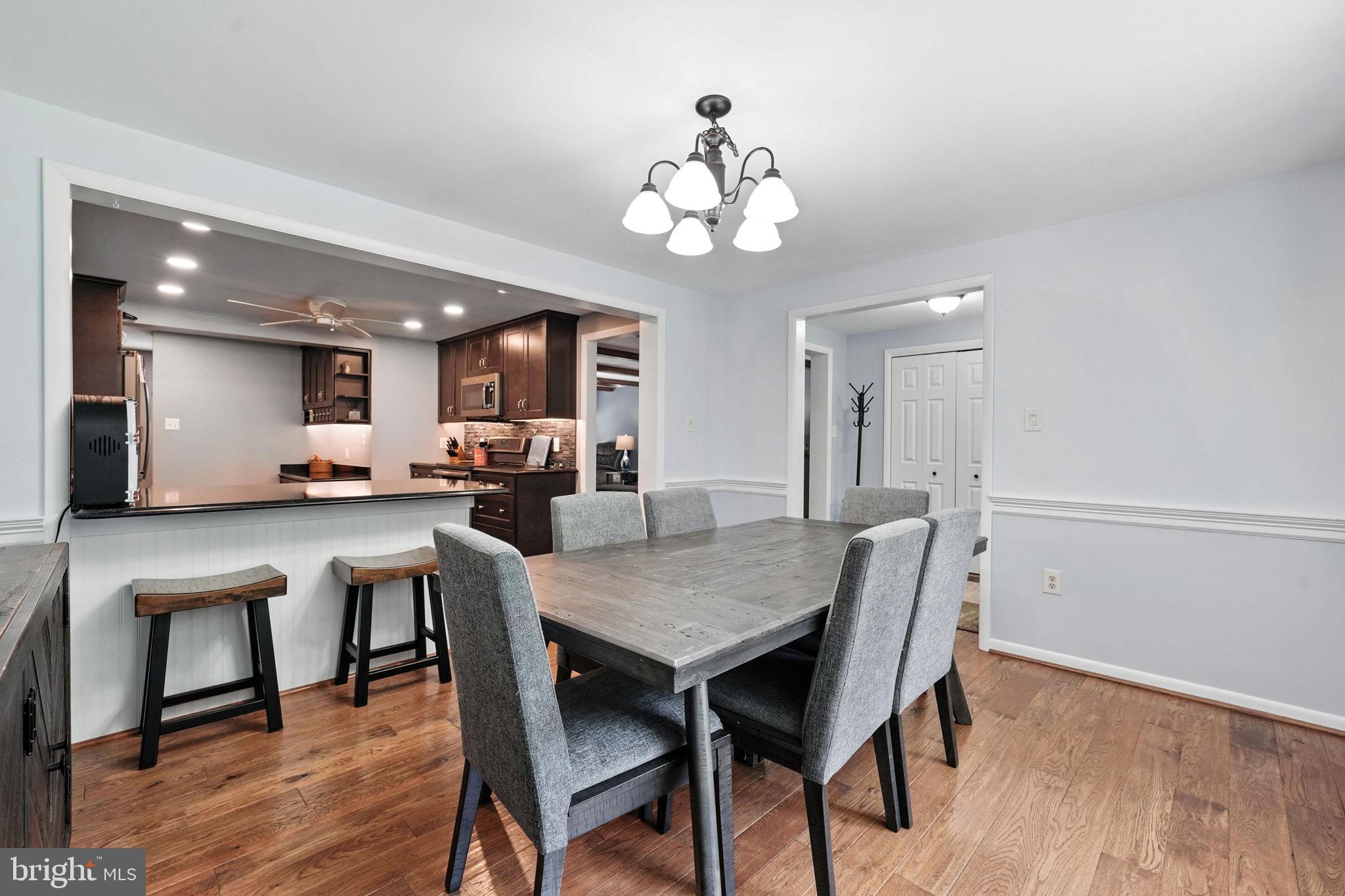 Dining room opens into kitchen with bar space