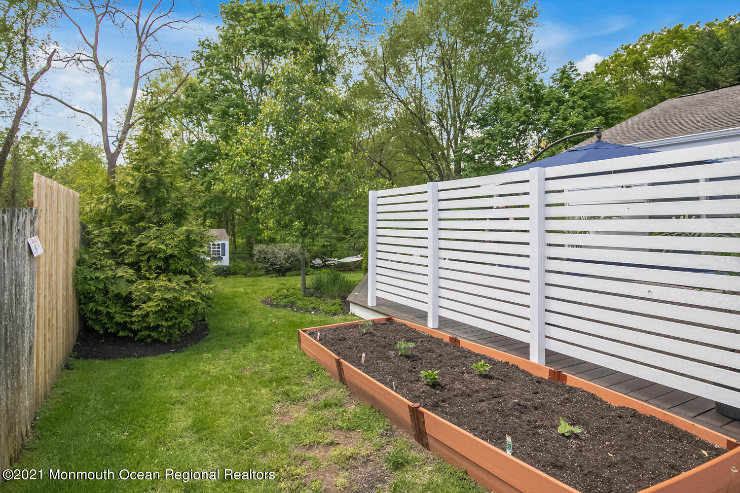 114 Garden Road Shrewsbury, NJ 07702 - Photo 22 of 25 a view of a backyard with plants and trees
